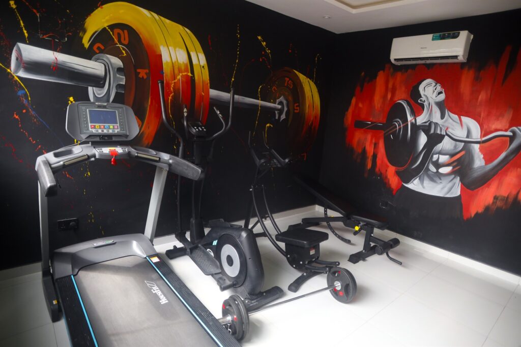 Brum Height 5: Gym with cardio equipment and a colourful wall mural